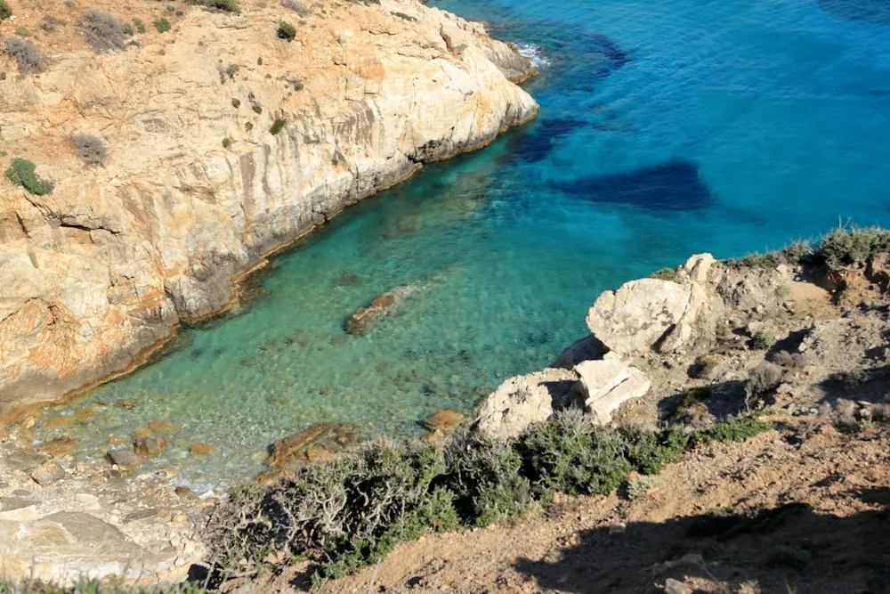 Pale rocks meeting clear turquoise water in a quiet Mediterranean cove
